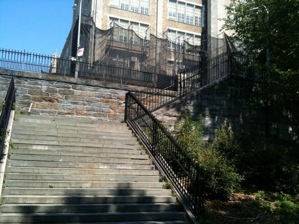 stone stairway leading to a tall building